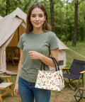 Woman holding Fennec Fox Insulated Lunch Box with large ears for women and girls, camping backdrop, pastel desert plants design.