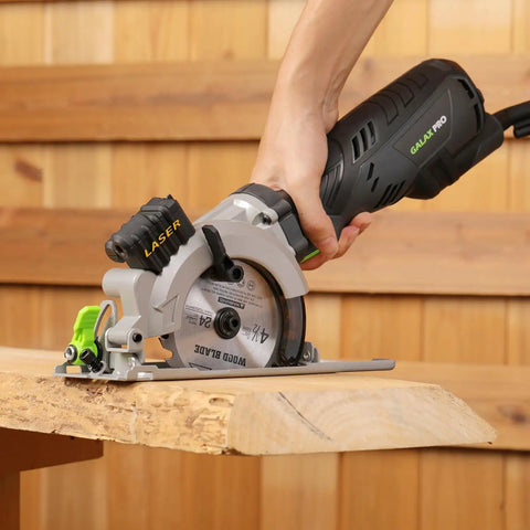 Powerful Compact Circular Saw With Laser Guide, 5.8 Amp, 3500 RPM, cutting wood on table with hand holding the handle
