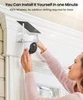 Person installing Wireless Outdoor Security Camera System With Solar Power 4 Camera 4MP HD Surveillance Base Station Local Storage