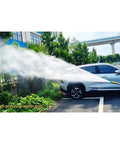 High pressure water gun spraying water on a parked car surrounded by greenery, showcasing powerful cleaning capability.