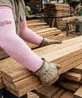Heavy Duty Cut Resistant Arm Sleeves With Thumb Holes For Mechanics And Glass Handling Shielding Delicate Skin Straight Up Like Body Armor In Pink Pair worn during woodworking tasks.