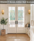 PENACINY Battery Operated Rattan Wall Sconces Set of 2 displayed in a bright entryway with double doors.