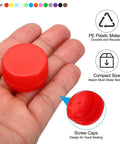 Hand holding orange plastic bottle cap from 50 pack of reusable screw lids for crafts, DIY scrapbooking, and empty containers.