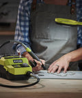 Badass 18 Volt Cordless Mini Rotary Tool With 35 Premium Accessories For Ultra Fast Diy Engraving Polishing And Precision Sanding Projects in use on a crafting table.