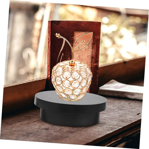 Electric Rotating Jewelry Display Turntable Motorized Showcase Stand For Photography Props with decorative apple figurine.