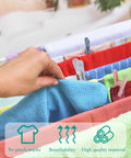 Hand using Solid Fifty Six Colorful Clothespins With Heavy Duty Spring Clips Measuring Two Inches to hang a blue towel.