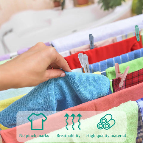 Hand using Solid Fifty Six Colorful Clothespins With Heavy Duty Spring Clips Measuring Two Inches to hang a blue towel.