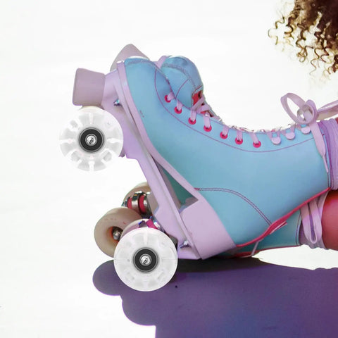 4 Piece Luminous PU Roller Skate Wheels Set With LED Light For Outdoor Quad Skates attached to blue skates