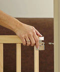 Hand installing Adjustable Wooden Baby Gate For Stairs From 28 To 42 Inches Wide And 30 Inches Tall, Kid Friendly Safe Gate