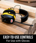 WorkTunes AM FM Hearing Protector With Built In Mic And High Fidelity Speakers on a woodworking bench
