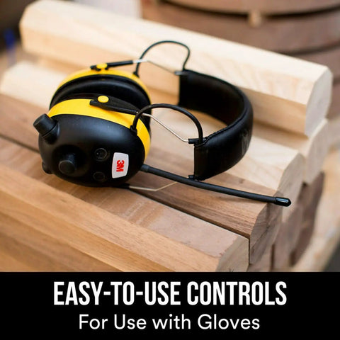WorkTunes AM FM Hearing Protector With Built In Mic And High Fidelity Speakers on a woodworking bench