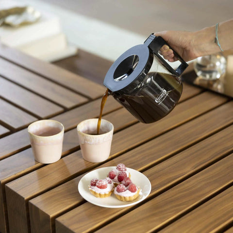 1.25L Glass Carafe for KBG Brewers, Clear Black Version, pouring coffee into cups on a wooden table with desserts