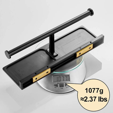 Double Roll Toilet Paper Holder With Shelf Matte Black Brass Finish on scale weighing 1077g, hotel-style, rust-resistant.