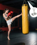 Woman kicking punching bag with overlay of 4-Wheel Silent Trolley Rollers For Strut Channel Fits 1-5/8 Inch Wide And Taller Channels