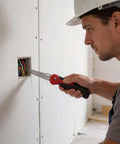 Person using Five In One Folding Hand Saw For Drywall And More With Quick Change Blades Great For Sheetrock Plywood PVC And Metal Cutting