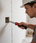 Person using 2 In 1 Folding Hand Saw For DIY Projects, Compact Drywall Cutter With Quick Change Multi Cutting Blade Hacksaw on sheetrock.
