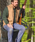 Hunter seated on lightweight 16x12 inch tree stand seat with pocket and adjustable straps, essential hunting accessory.