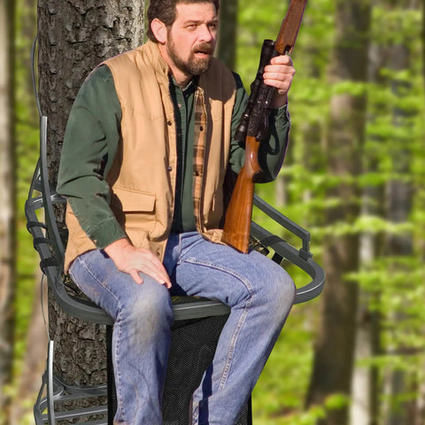 Hunter seated on lightweight 16x12 inch tree stand seat with pocket and adjustable straps, essential hunting accessory.