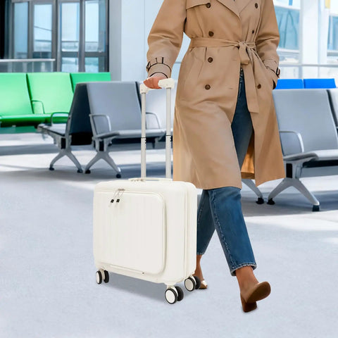 Person in a coat walking with an 18 Inch Underseat Carry On Luggage With USB Port And Password Lock Hard Shell Rolling Suitcase