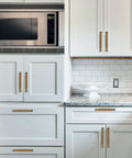 Installed 10 Pack 5 Inch Cabinet Pulls Antique Brass Zinc Alloy Drawer Pulls on white kitchen cabinets