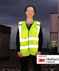 Heavy Duty Breakaway Mesh Hi Vis Safety Vest With 3M Reflective Strips worn by a person in low light conditions.