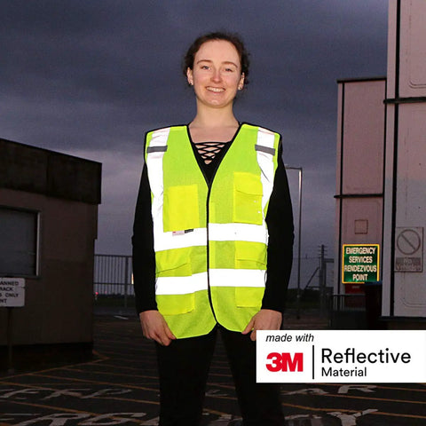 Heavy Duty Breakaway Mesh Hi Vis Safety Vest With 3M Reflective Strips worn by a person in low light conditions.