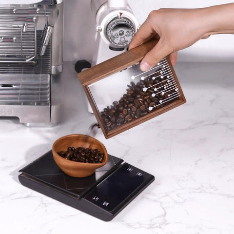Handcrafted Solid Wood Coffee Bean Jar With Reliable One Way Degassing Valve And Heavy Duty Rubber Seal Keeps Your Daily Grind Fresh As Heck And Ready For Brewing On The Kitchen Counter being used to pour beans into a wooden bowl.