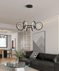 Dope Modern LED Chandelier With Six Black Ring Pendant Lights hanging in a living room