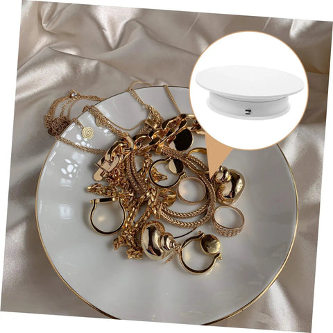 Autonomic Electric Rotating Display Stand For Jewelry Watches And Collectibles With Adjustable Speed smooth turntable showcasing gold jewelry on a plate.