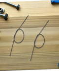 Fresh And Tough Earless Pointed Compression Springs 20 Pack Of 304 Stainless Steel Assortment Kit Perfect For Oil Seal Replacements Industrial Machines And Bag Making Gigs That Rock Hard Like A Boss. Two stainless earless pointed springs on wood table.