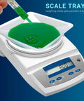 Disposable 330mL Weigh Boats Pack Of 125 Large Plastic Weighing Dishes For Lab Use Food Safe Antistatic Polystyrene Great For Measuring Powders Liquids Supplements And Food Samples With Easy Cleanup, white weigh boat on scale with green liquid