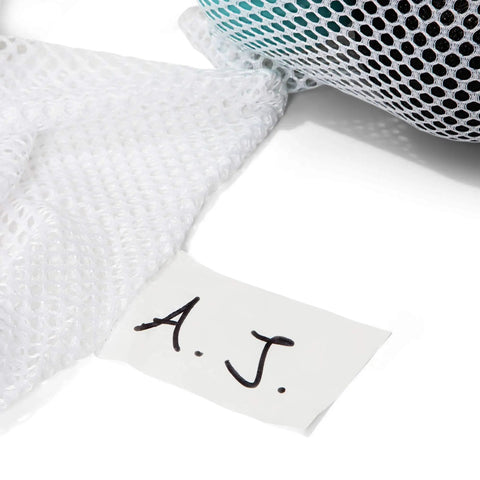 Breathable Mesh Sports Equipment Bag 12x18 Inch with ID tag, close-up of white mesh fabric and handwritten initials "A.J."