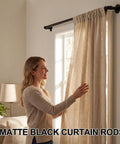 Person adjusting curtains on industrial black curtain rods 18 to 88 inch adjustable length 1 inch diameter pipe for wall mount
