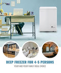No Sweat Compact Chest Freezer With Dual Removable Baskets And Precision Digital Display To Keep Your Grocery Stash Rock Solid Cold In White Finish Quick Freeze Unit beside a modern desk and workspace.