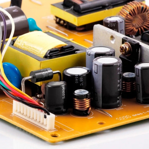 Close-up of circuit board featuring electrolytic capacitor kit from 0.1uF to 1000uF, 15 value assortment, aluminum, for electronics.