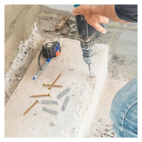 Person using drill near Beefy Self Drilling Metal Serrated Expansion Screws Set For Concrete Walls And Fasteners Kit on concrete step