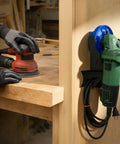 4 Pack Angle Grinder Holders Wall Mount Rack with Cord Hanger for 5 Inch Grinders, holding a green grinder in a workshop