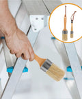 Hand holding Two Pack Wood Handle Paint Brushes For Walls And Deck Stain, Oval Synthetic Bristle Set For Furniture And Latex Paint Application