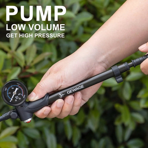 Hand holding High Pressure Shock Pump For Mountain, Road Bikes And Motorcycles With Gauge, 300 Psi Capacity, compact design