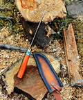 Dope Copper Damascus Fixed Blade Knife With Resin Handle And Premium Leather Sheath on wood stump, outdoor setting