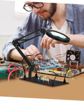 Man using Six Piece Soldering Arm Set With Flexible Clamp Holder For Welding Clamps And Magnifying Glass Lamps on circuit board