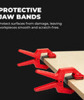 Red edge band spring clamps securing wood piece, part of a set of four for woodworking and home improvement projects.