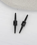 Black aluminum Ten Pack 26mm Bicycle Cable Connectors For Brake And Shift Cables, 2mm Aperture, ultra light, shown on gray surface.