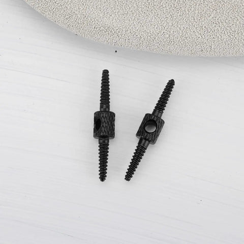 Black aluminum Ten Pack 26mm Bicycle Cable Connectors For Brake And Shift Cables, 2mm Aperture, ultra light, shown on gray surface.