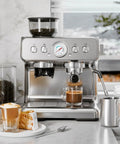 Top Shelf Espresso Machine With Built In Grinder And 20 Bar Pressure, brushed silver finish and milk frother with espresso.