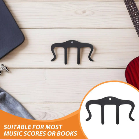 Three Pack M Shaped Metal Sheet Music Clip Bookmark Black For Page Markers And Score Holders Keeps Your Sheet Music In Place During Practice And Performances Like A Pro., black metal M-shaped sheet music clip bookmark on wood surface