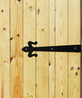 Weld-On Rising Butt Gate Hinge For Wood Doors And Cabinets installed on wooden gate with detachable design for outdoor use