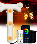 12 Foot Skeleton Light Kit With RGB Color Changing LEDs Outdoor Halloween Decor in a spooky yard with remote and cord visible