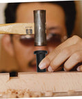 Person installing Heavy-Duty Barn Door Track Spacers Kit With Screws, using hammer on carbon steel wall connector on wood surface