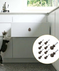 A cat reaches for a cabinet with Vintage Bronze Cabinet Drawer Handles 10 Pack Alloy Door Pulls for furniture and wardrobe.